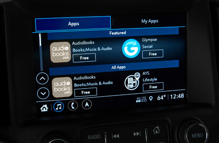 2018 GMC Terrain infotainment screen showing different features and menu options including Apps, My Apps, AudioBooks, books music and audio, Glympse Social, AYS Lifestyle, and the current time and temperature