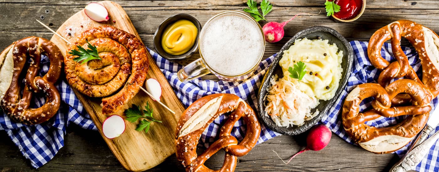 Oktoberfest food is on a table. Visit the event after checking out used luxury cars at Frank Kent.