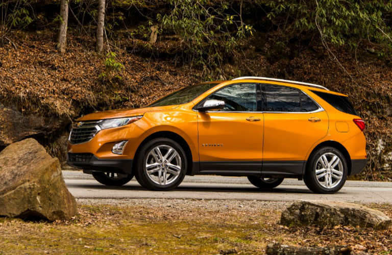 orange 2019 Chevy Equinox on forest road