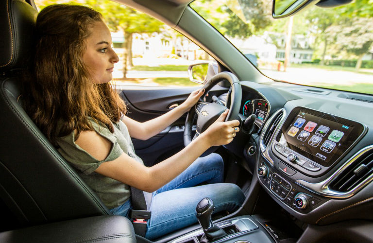 photo of a teenage driver behind the wheel of the 2018 Chevy Equinox using Chevy Teen Driver Technology
