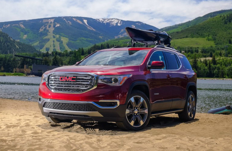2018 GMC Acadia with canoe on top near water