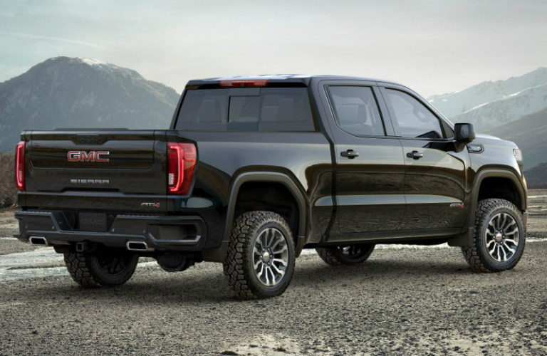 2019 GMC Sierra AT4 exterior rear quarter view with mountain background