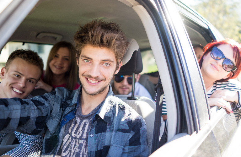 Young people packed into a car for a road trip